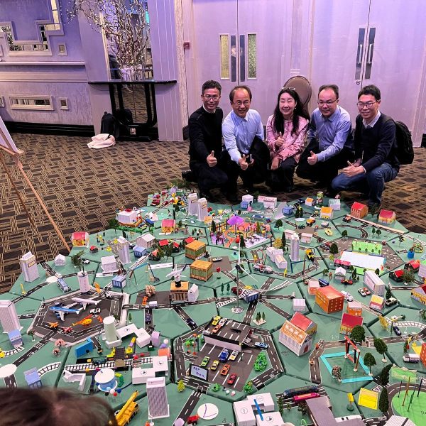 Delegates showcasing their miniature city that they built as part of Orangeworks creative construction based team activity called City Build.