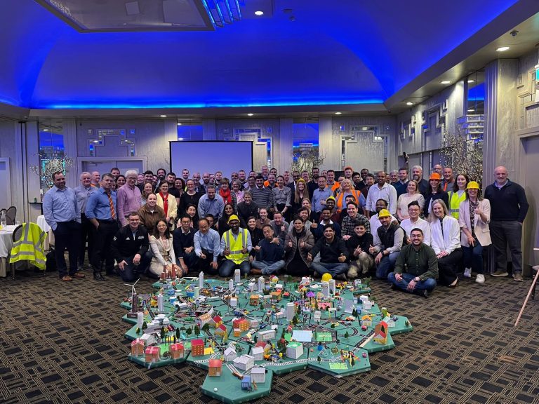 Delegates showcasing their miniature city that they built as part of Orangeworks creative construction based team activity called City Build.