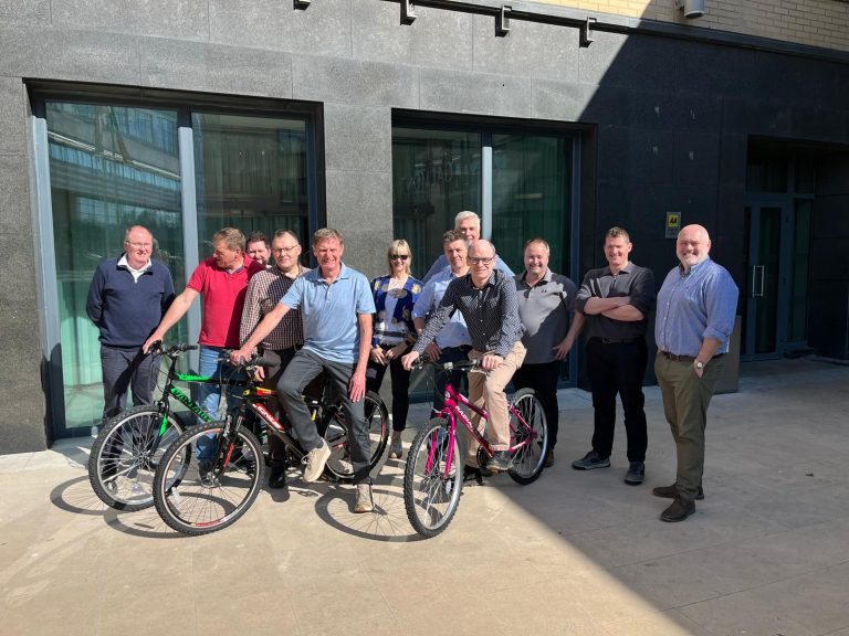 Delegates taking part in Orangeworks csr charity based activity where they build bikes and donate them to local charities.