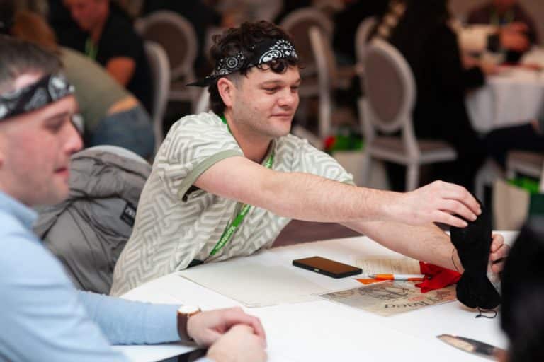 Delegates enjoying Orangeworks team development negotiation game called Trade Winds.