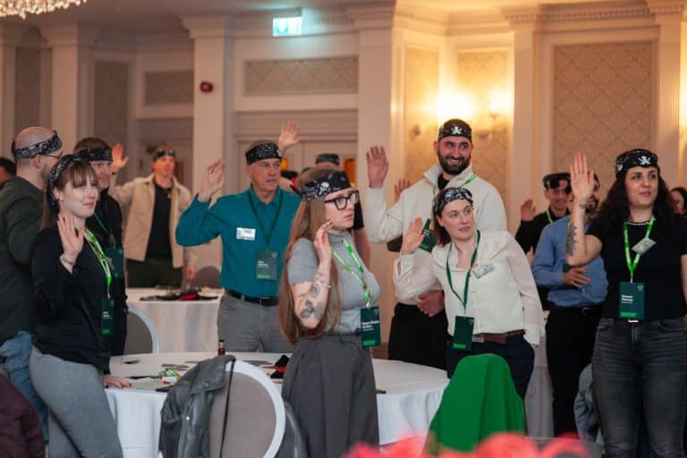 Delegates enjoying Orangeworks team development negotiation game called Trade Winds.